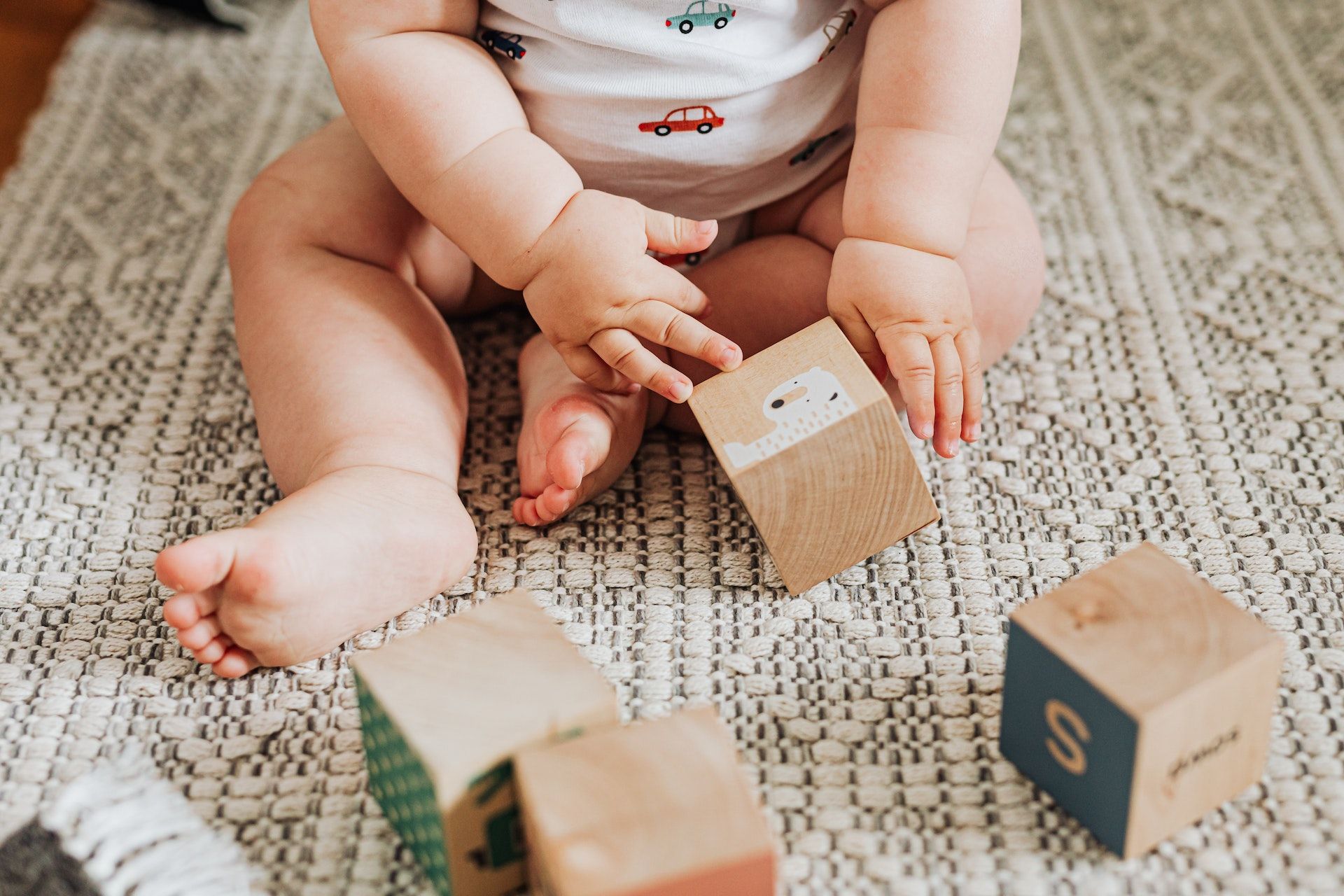 Baby plays with block toys.