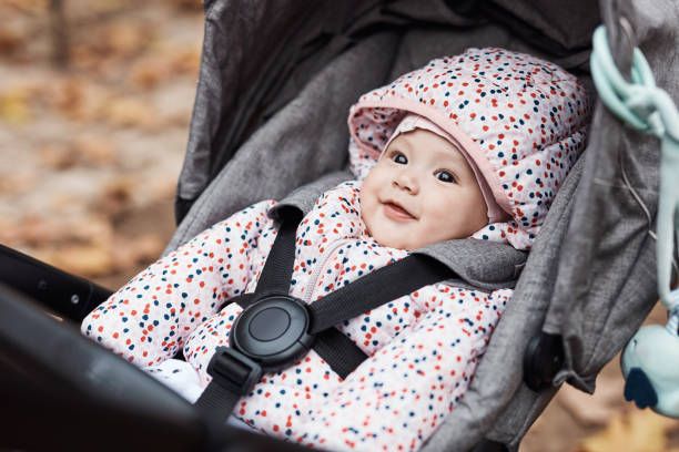 Baby smiling in pushchair.