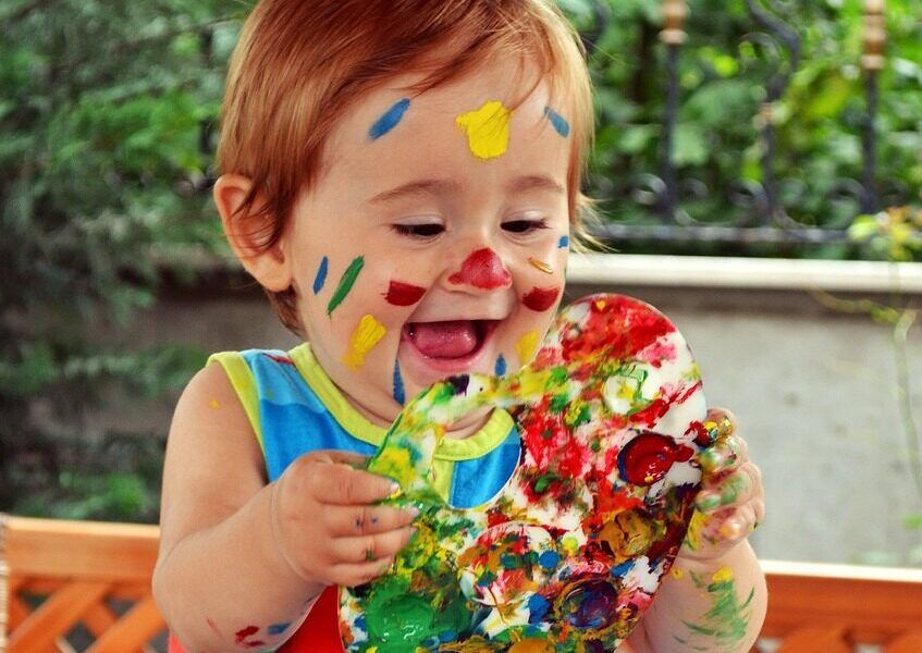 baby playing with messy paint.