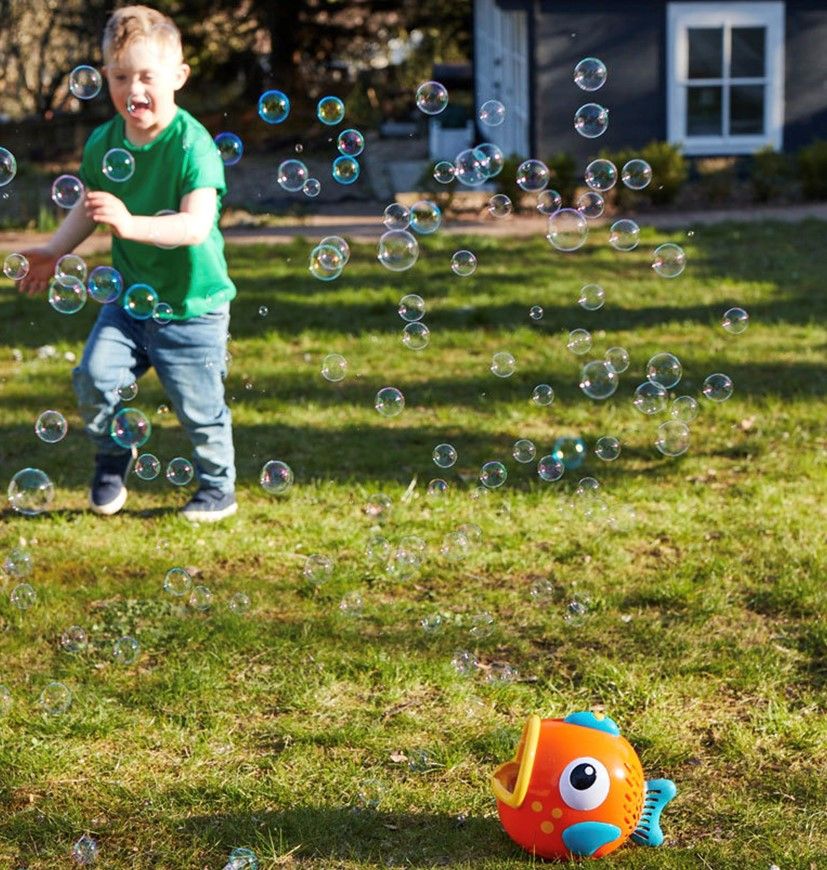 Child plays with bubbles outdoor